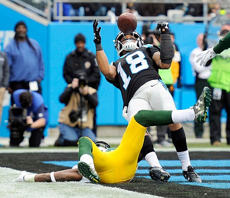 Damiere Byrd of the Panthers catches a touchdown pass over Josh Hawkins of the Packers during the second half of Sunday's game in Charlotte, N.C.