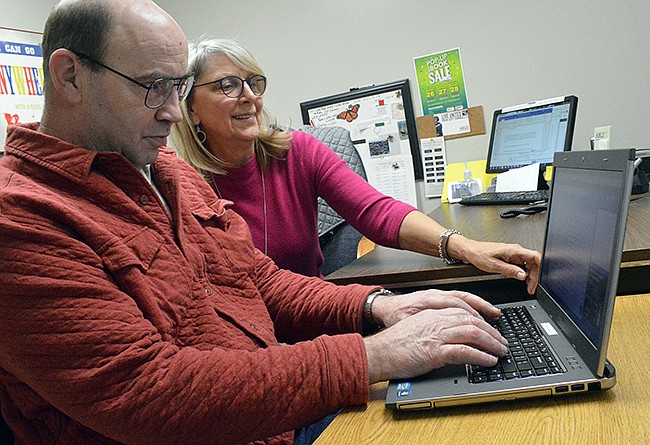 Alan Stoutz receives instruction from Felicia Poettgen, director of the ABLE Learning Center.