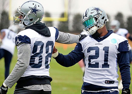 Cowboys wide receiver Dez Bryant (88) talks with running back Ezekiel Elliott (21) as they stretch together at practice Wednesday in Frisco, Texas.