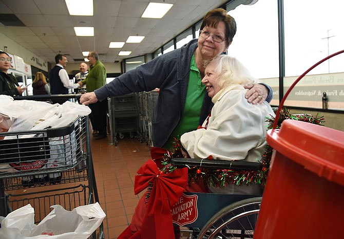 Barbara Coleman, left, congratulates Elisabeth Long on Friday at Schulte's Fresh Food as she was recognized for her service to the Salvation Army over the years by ringing bells at Christmas to collect money for the annual Red Kettle campaign. Over the course of 28 years, she's collected about $180,000 for the Salvation Army. 