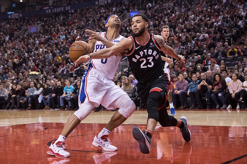 Toronto Raptors' Fred VanVleet, right, steals the ball from Philadelphia 76ers Jerryd Bayless during first half NBA basketball action in Toronto on Saturday, Dec. 23, 2017. 