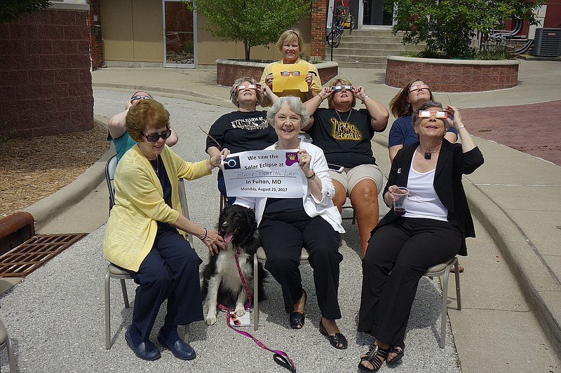 FILE: A group of friends including those from the Kingdom of Callaway Historical Society, along with Renee Graham (standing in the back), Callaway County tourism director, gathered to watch the solar eclipse in a parking lot off Nichols Street in 2017. Graham has been instrumental in planning eclipse activites in Callaway County for more than a year.
