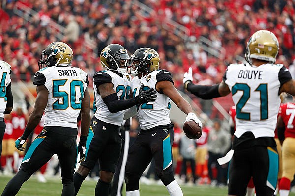Jaguars strong safety Barry Church celebrates with teammates after intercepting a pass during Sunday's game against the 49ers in Santa Clara, Calif.