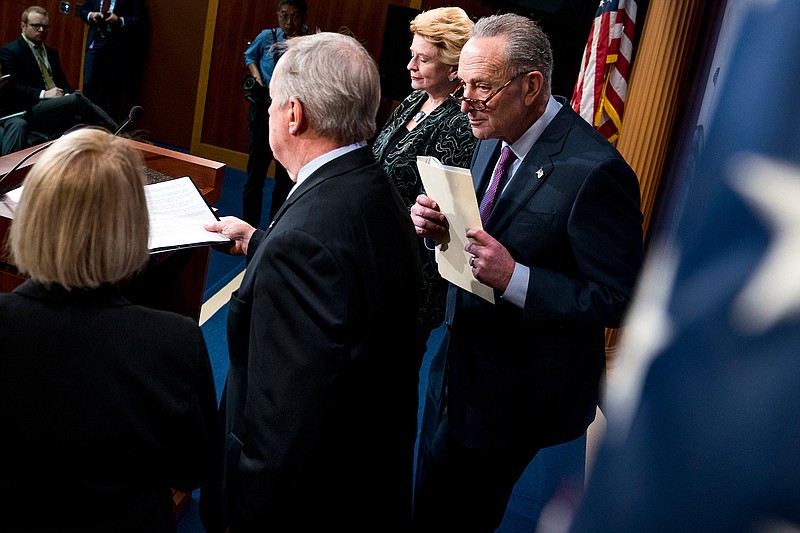 In this Dec. 21, 2017, photo, from left, Sen. Patty Murray, D-Wash., Sen. Dick Durbin, D-Ill., Sen. Debbie Stabenow, D-Mich., and Senate Minority Leader Sen. Chuck Schumer of N.Y., hold a news conference on Capitol Hill in Washington, on a review of the Republican agenda this past year. Their tax bill triumph in the rear-view mirror, Republicans running Congress face a 2018 in which they'll need Democratic votes to get almost anything done.