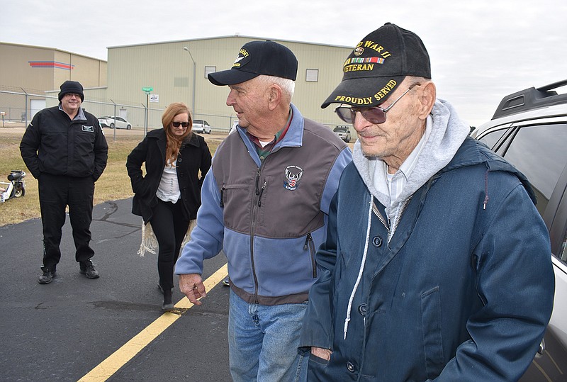 Helicopter pilot Don Ruggles, 82, center, walks with Owen Brainard, 92, after the pilots flew over Texarkana about noon Wednesday. Brainard was a helicopter pilot during the Korean War in the early 1950s, and the flight Wednesday was his first in 65 years. In the background is LifeNet pilot John Buchanan.