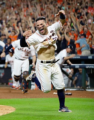 In this Oct. 14 file photo, Jose Altuve of the Astros reacts after scoring the game-winning run during the ninth inning of Game 2 of the American League Championship Series against the Yankees in Houston.