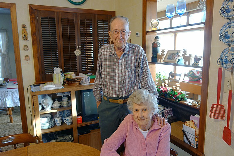 Centenarian farmer, retired electrictian and Airforce veteran Albin Linsenbardt stands with his wife, Jackie, in their Lohman farmhouse.