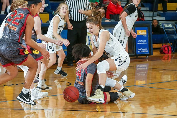 Ellie Rockers of the Helias Lady Crusaders tangles with Gabby Fuller of St. Joseph Benton for control of a loose ball during Friday night's game at Rackers Fieldhouse.