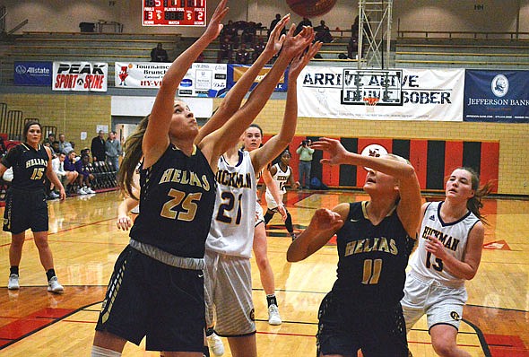 Ellie Rockers of Helias reaches for a rebound Saturday against Hickman at Fleming Fieldhouse.