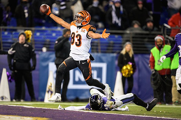 Bengals wide receiver Tyler Boyd reacts as he scores the winning touchdown as Ravens cornerback Brandon Carr lies on the ground during the second half of Sunday's game in Baltimore. The Bengals defeated the Ravens 31-27.