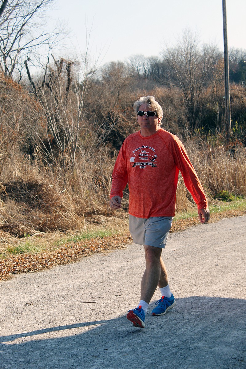 Kevin Stock warms up by power walking along the Katy Trail.