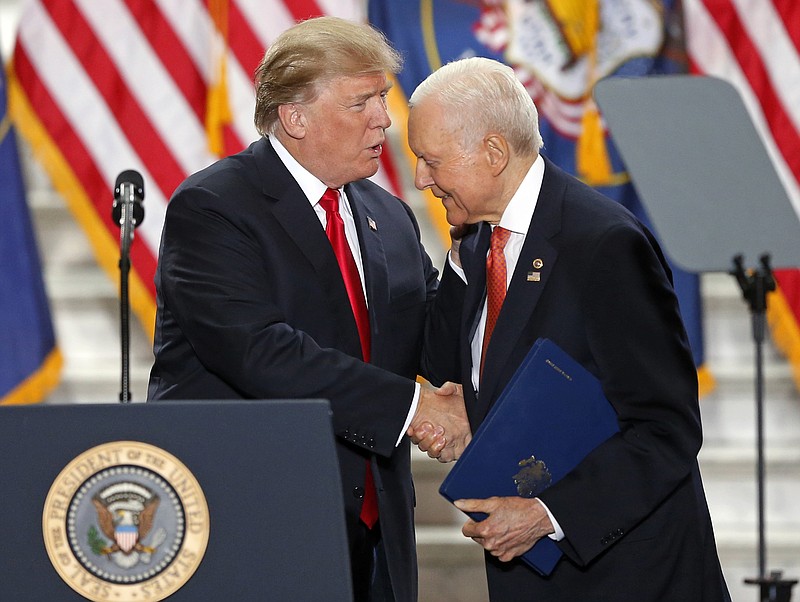 FILE - In this Dec. 4, 2017, file photo, President Donald Trump shakes Sen. Orrin Hatch, R-Utah, hand at the Utah State Capitol in Salt Lake City. Hatch says he will not seek re-election after serving more than 40 years in the U.S. Senate. Hatch, 83, says he’s always been a fighter, “but every good fighter knows when to hang up the gloves.” (AP Photo/Rick Bowmer, File)