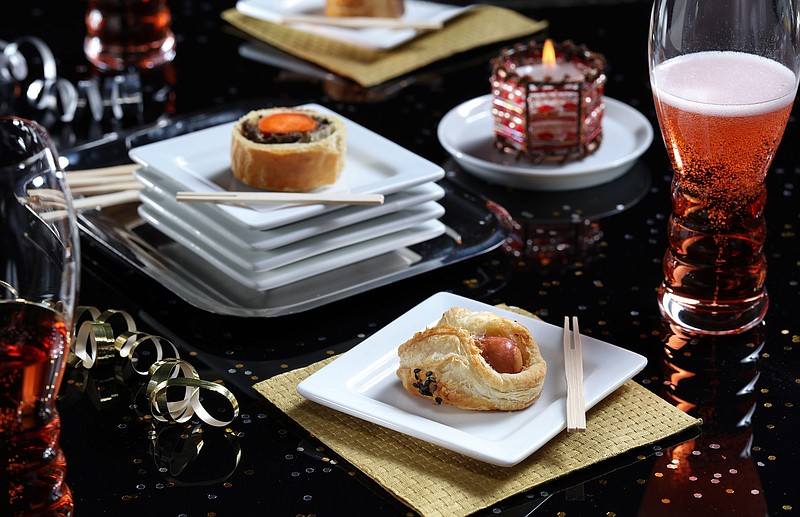 Sausage turnovers (aka pigs in blanket), foreground, are a step up from the usual when wrapped in puffed pastry, on Tuesday Dec., 12, 2017. 