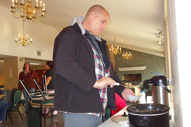  Helen Wilbers/FULTON SUN
Paul Ransdell, a regular visitor to the Fulton Soup Kitchen, ladles out a bowl of piping-hot mutton-vegetable soup. The soup kitchen is seeking donations after its cooler broke down last weekend.