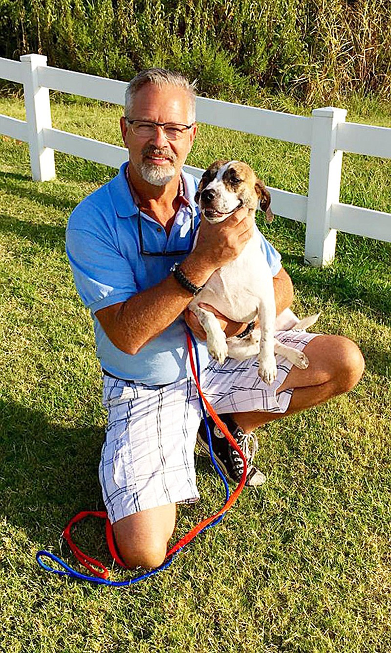 Bill Kinsinger sits with a rescue dog. His plane went missing near the Gulf of Mexico on Wednesday.