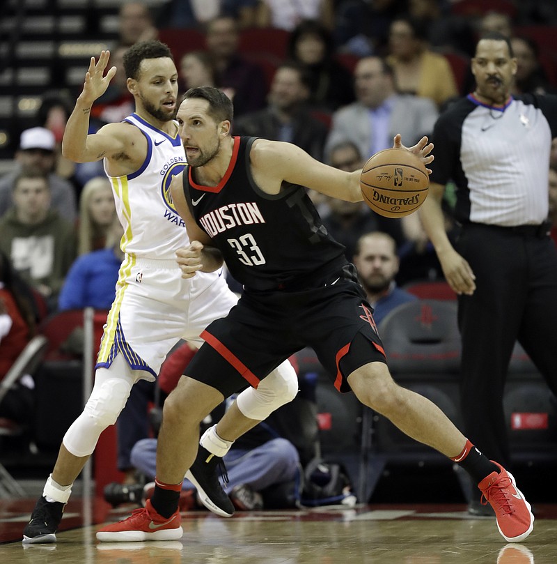 Houston Rockets' Ryan Anderson (33) drives toward the basket as Golden State Warriors' Stephen Curry defends during the first half of an NBA basketball game Thursday, Jan. 4, 2018, in Houston. 