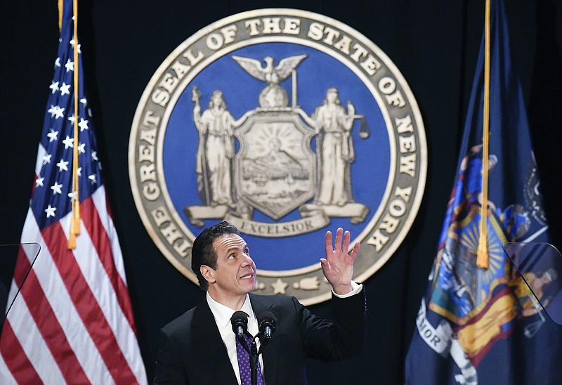 FILE - In this Wednesday, Jan. 3, 2018 file photo, New York Gov. Andrew Cuomo makes reference to his father Mario Cuomo as he delivers his state of the state address at the Empire State Plaza Convention Center in Albany, N.Y. During the speech, Cuomo pledged to sue over the new federal tax plan, which he called “an assault” by the federal government. (AP Photo/Hans Pennink)