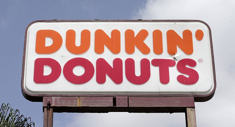 This Aug. 3, 2017, photo shows a Dunkin' Donuts sign at a store in Hialeah, Fla. Dunkin' Donuts is cutting back on its food and drink offerings. The Boston Herald reports the new, simplified menu is expected to roll out in New England locations starting Monday, Jan. 8, 2018, before expanding nationwide in mid-March. (AP Photo/Alan Diaz, File)