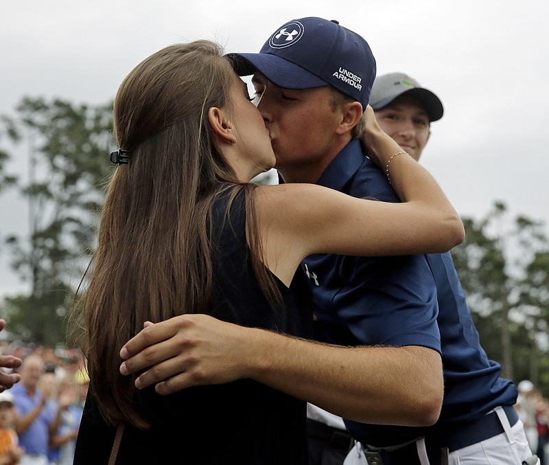 In this Sunday, April 12, 2015 file photo,  Jordan Spieth kisses his girlfriend, Annie Verret, after winning the Masters golf tournament in Augusta, Ga. Spieth confirmed on Tuesday, Jan. 2, 2018 that he is now engaged to Verret.
