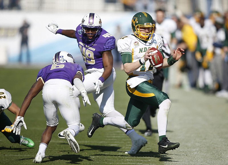 North Dakota State quarterback Easton Stick (12) runs out of bounds after making the first down as James Madison cornerback Jimmy Moreland (6) closes in on the play during the first half  in the FCS championship NCAA college football game at Toyota Stadium in Frisco, Texas, Saturday, Jan. 6, 2017. 