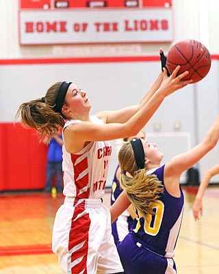 Calvary Lutheran's Katy Allen catches a pass over Chamois' MaKenna Wuelling during Saturday's title game in the Calvary Lutheran Tournament.