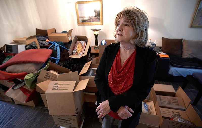 Deb Eberhart stands in her living room full of boxes Friday, Dec. 15, 2017, in Houston. Eberhart, who recently returned to her remodeled home, had to evacuate during Hurricane Harvey as floodwaters filled her neighborhood. A group of psychologists has offered free counseling sessions to people working to recover from Harvey. Eberhart sought out the counseling sessions after realizing that the stress from the whole situation had left her frequently in tears and grinding her jaw. 