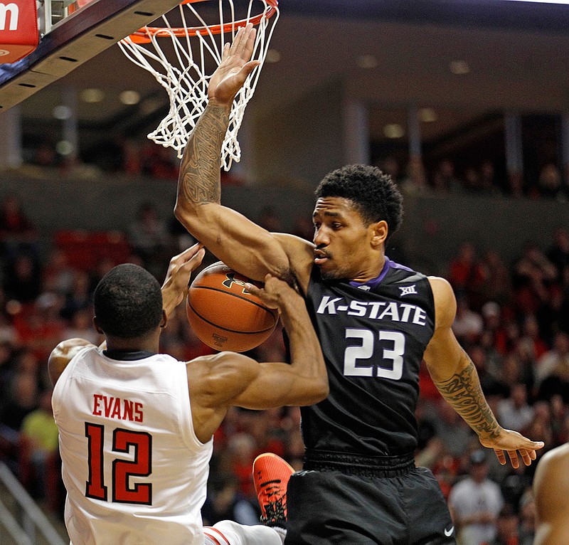 Kansas State's Amaad Wainright (23) fouls Texas Tech's Keenan Evans (12) who tries to shoot the ball during the second half of an NCAA college basketball game Saturday, Jan. 6, 2018, in Lubbock, Texas.