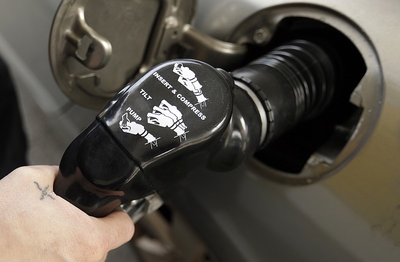FILE - In this May 6, 2015, file photo, instructions are visible on a handle as gas is pumped at a station in Portland, Ore. An Oregon law passed nearly seven decades ago banned drivers from pumping their own gas but now that's changing, in some cases. The new year ushered in some modifications to the aging law that makes Oregon only one of two states in the U.S. that places restrictions on self-service gas. (AP Photo/Don Ryan, File)