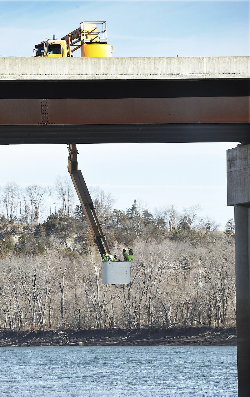In this January 2018 photo, Kevin Wagner photographs the underside of the westbound U.S. 50/63 bridge over the Osage River as he and Tony Welschmeyer, both members of MoDOT's Bridge Inspection crew, perform a regularly scheduled inspection of the bridge. The westbound bridge was built in 1952 and underwent rehabilitation in 2002.
