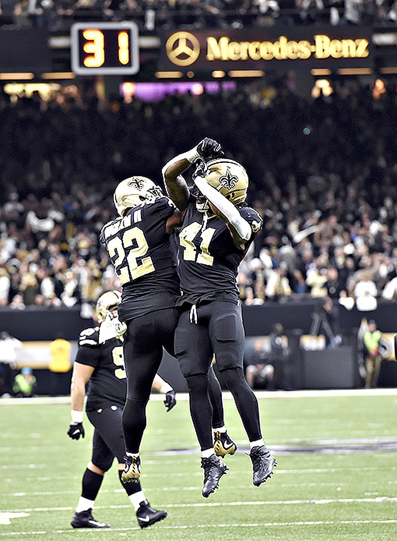 New Orleans Saints running back Alvin Kamara (41) celebrates his touchdown carry with running back Mark Ingram (22) in the second half against the Carolina Panthers on Sunday in New Orleans.