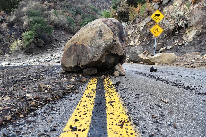 A large boulder sits in the middle of Bella Vista Drive in Montecito, Calif., following the rain storm, Tuesday, Jan. 9, 2018.