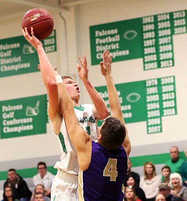 Dru Rackers of Blair Oaks puts up a shot over Graham Moser of Hallsville during Tuesday night's game in Wardsville.