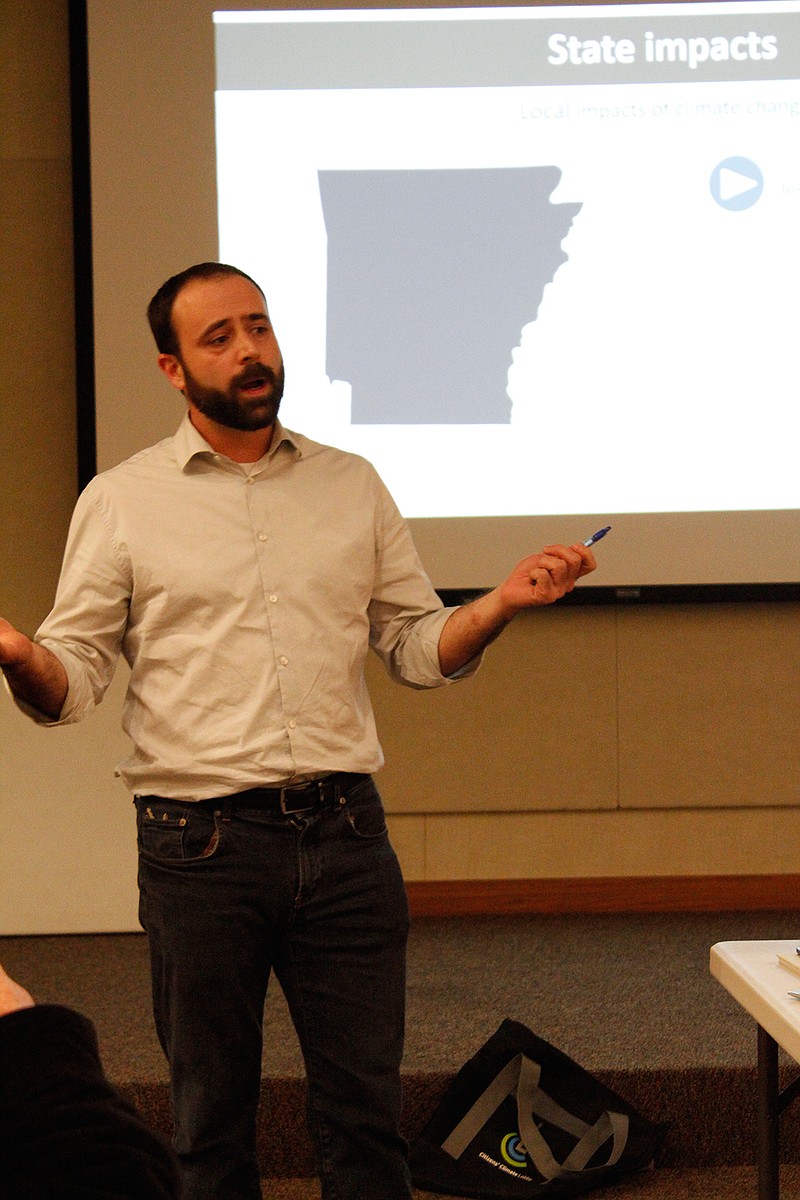 Chris McNamara, Arkansas coordinator for Citizens Climate Lobby, speaks Monday at a meeting of Friends United for a Safe Environment. Citizens Climate Lobby is working to place a cost on fossil fuels, and those funds would then be returned to the public to alleviate the burden of transitioning into a clean energy economy.