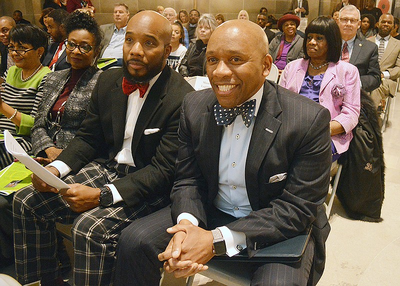 David Johnson, left, and keynote speaker Dr. Kevin McDonald listen to opening remarks Tuesday during King 50, a commemoration of Martin Luther King Jr. hosted by the Missouri Legislative Black Caucus, at the Capitol.