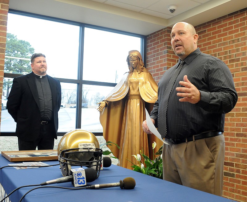 New and returning Helias Catholic High School head football coach Chris Hentges is introduced during a news conference Thursday, Jan. 11, 2018, as Helias President the Rev. Stephen Jones looks on. Hentges was the Crusaders' head football coach from 2006-10.