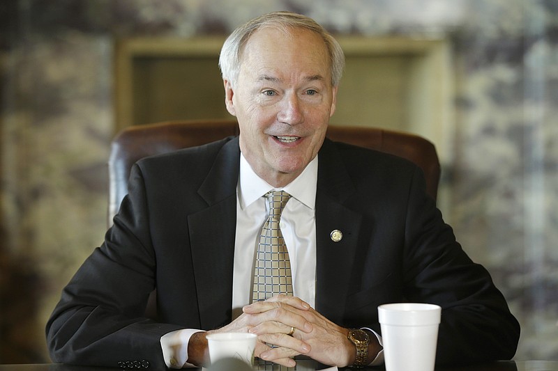 In this photo taken Jan. 14, 2015, Arkansas Gov. Asa Hutchinson presides over a meeting of the state Board of Finance at the Arkansas state Capitol in Little Rock, Ark. 