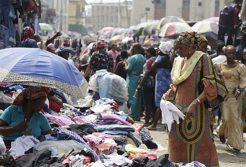 Pedestrians shop in a roadside market in Lagos, Nigeria, Friday, Jan. 12, 2018. Africans were shocked on Friday to find President Donald Trump had finally taken an interest in their continent. But it wasn't what people had hoped for. Using vulgar language, Trump on Thursday questioned why the U.S. would accept more immigrants from Haiti and "shithole countries" in Africa rather than places like Norway in rejecting a bipartisan immigration deal. On Friday he denied using that language. (AP Photo/Sunday Alamba)