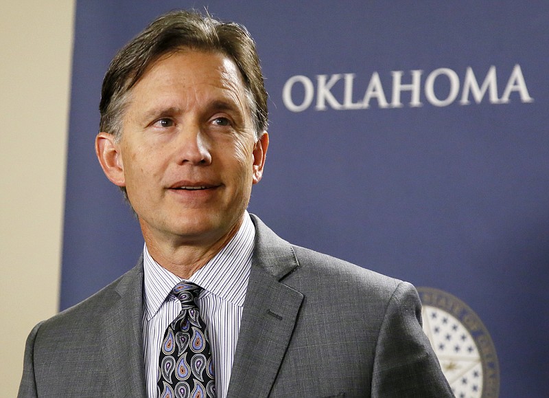 FILE - In this April 26, 2017, file photo, Oklahoma Attorney General Mike Hunter speaks at a news conference in Oklahoma City. Oklahoma is one of at least 13 states that have filed lawsuits against drugmakers, alleging fraudulent marketing of drugs that fueled the opioid epidemic. Hunter says a judge has granted his request for a May 28, 2019, trial date for the lawsuit against Purdue Pharma, Allergan, Janssen Pharmaceuticals, Teva Pharmaceuticals and several of their subsidiaries. (AP Photo/Sue Ogrocki, File)