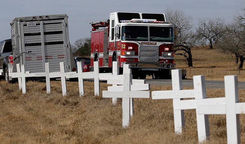 Ryland Ward, who was shot during a Nov. 5 church shooting, looks out the passenger window as he passes a memorial of crosses as he returns home after his release from the hospital in the cab of a firetruck, Thursday, Jan. 11, 2018, in Sutherland Springs, Texas. Ward, 6, was shot several times and was the last victim still hospitalized following the church massacre in South Texas. 