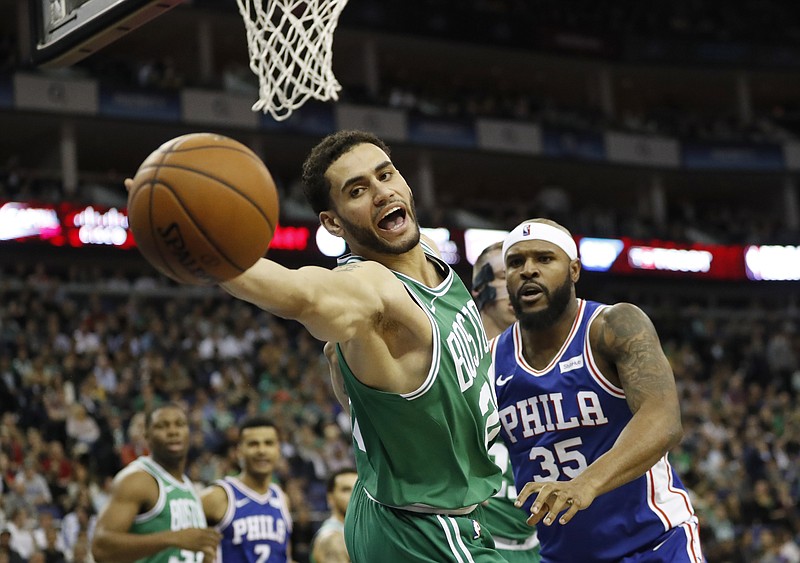 Boston Celtics forward Abdel Nader, left, reaches out for the ball during an NBA basketball game between the Boston Celtics and the Philadelphia 76ers at the O2 Arena in London, Thursday, Jan. 11, 2018. 
