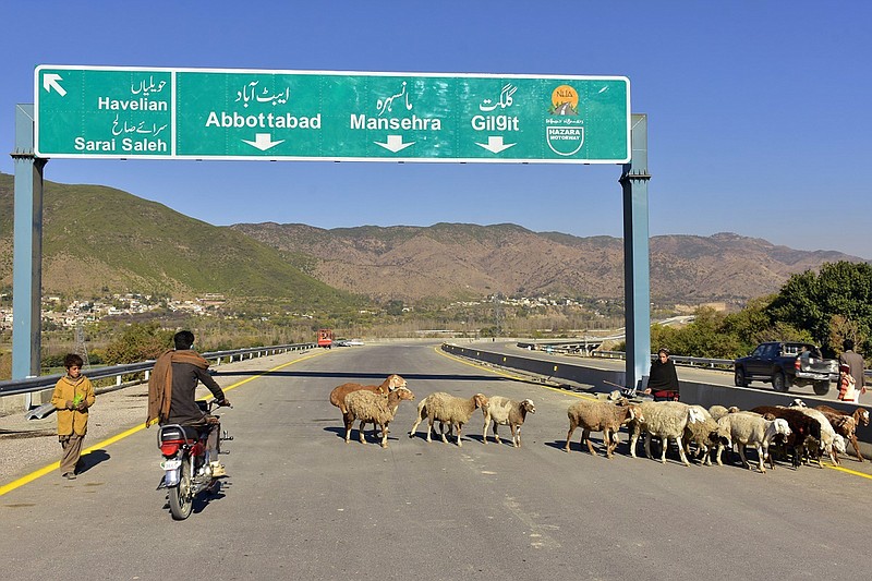 In this Dec. 22, 2017, photo, a Pakistani motorcyclist drives on a newly built Pakistan China Silk Road in Haripur, Pakistan. From Pakistan to Tanzania to Hungary, projects under Chinese President Xi Jinping's signature "Belt and Road Initiative" are being canceled, renegotiated or delayed due to disputes about costs or complaints host countries get too little out of projects built by Chinese companies and financed by loans from Beijing that must be repaid. (AP Photo/Aqeel Ahmed)