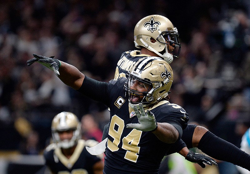 In this Jan. 7, 2018, file photo, New Orleans Saints defensive end Cameron Jordan (94) celebrates a defensive stop in the second half of an NFL football game against the Carolina Panthers, in New Orleans. Newly named All-Pro for the first time, Saints defensive Cam Jordan takes his playful yet menacing presence this weekend to the city where his father became a Pro Bowl tight end. 