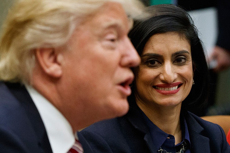 In this March 22, 2017 file photo, Administrator of the Centers for Medicare and Medicaid Services Seema Verma listen at right as President Donald Trump speaks during a meeting in the Roosevelt Room of the White House in Washington. The Trump administration says it's offering a path for states that want to seek work requirements for Medicaid recipients, and that's a major policy shift toward low-income people. 