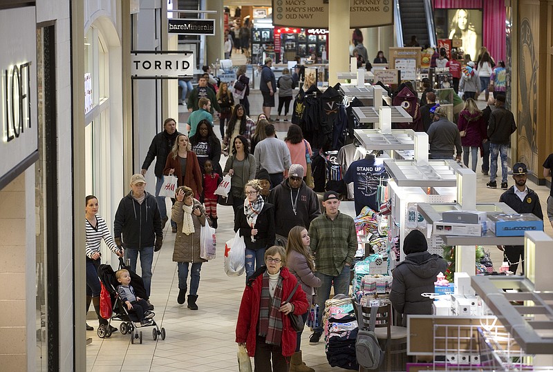 FILE - In this Tuesday, Dec. 26, 2017, file photo, shoppers take advantage of discounts and slashed post-Christmas prices at Valley View Mall in Roanoke, Va. The National Retail Federation said Friday, Jan. 12, 2018, that holiday sales reached $691.9 billion as shoppers stepped up their spending in the wake of a better economy. (Erica Yoon/The Roanoke Times via AP, File)