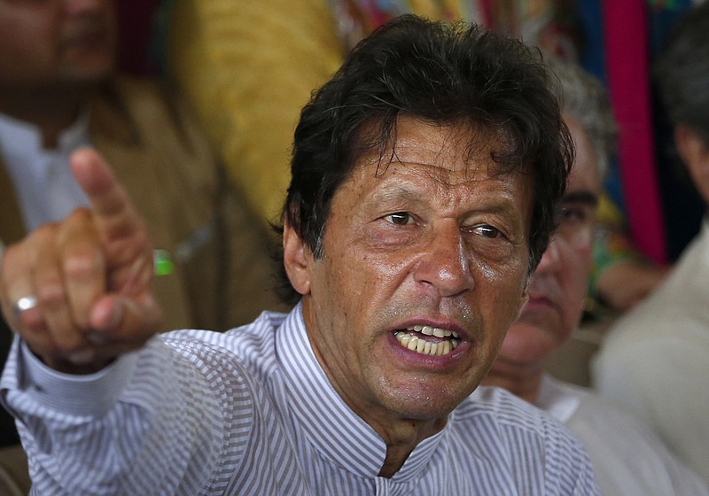 FILE - In this July 28, 2017 file photo, Pakistani opposition leader Imran Khan gestures during a news conference in Islamabad, Pakistan. Khan said Saturday, Jan. 13, 2018 that meeting U.S. President Donald Trump would be a "bitter pill" to swallow should he become Pakistan's prime minister in elections later this year, but added "I would meet him." (AP Photo/Anjum Naveed, File)