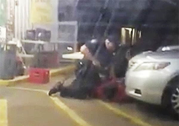 FILE - In this file image made from video, taken July 5, 2016, Alton Sterling is held by two Baton Rouge police officers, with one holding a hand gun, outside a convenience store in Baton Rouge, La. Moments later, one of the officers shot and killed Sterling. The criminal investigation of Alton Sterling's fatal shooting has lasted more than a year-and-a-half, and there's no clear end in sight. A federal investigation of the shooting lasted nearly 10 months before the Justice Department ruled out federal charges against the officers. More than eight months have passed since Louisiana Attorney General Jeff Landry's office inherited the case to decide if any state charges are warranted. (Arthur Reed via AP, File)