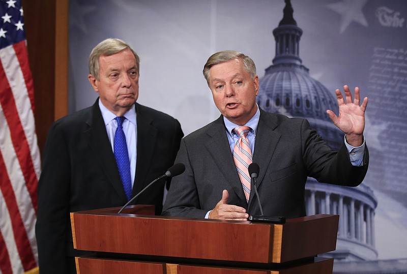 FILE - In this Tuesday, Sept. 5, 2017, file photo, Sen. Lindsey Graham, R-S.C., right, with Sen. Dick Durbin, D-Ill., speak during a news conference on Capitol Hill in Washington, to discuss their bipartisan Dream Act. A 12-year pathway to citizenship for young immigrants brought to the U.S. as children and who are here illegally is part of a bipartisan immigration proposal by senators to prevent deportation of hundreds of thousands of so-called Dreamers. The Associated Press on Saturday, Jan. 13, 2018 obtained details of the agreement between three Republican and three Democratic senators. The deal also calls for allocating $1.6 billion for structures including a wall for border security. (AP Photo/Manuel Balce Ceneta, File)