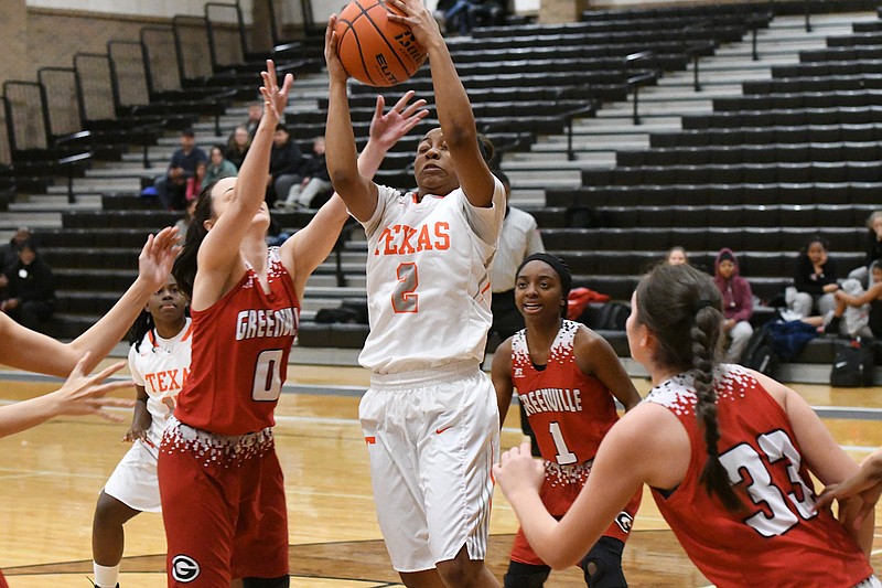 Texas High guard Kiasyia Morrison pulls down a rebound in front of Greenville's Allison Gilmore, left, during a District 16-5A game Friday at Tiger Center. The Lady Tigers won, 74-24, to close out the first half of league play with a 5-1 record. (Photo by Kevin Sutton)