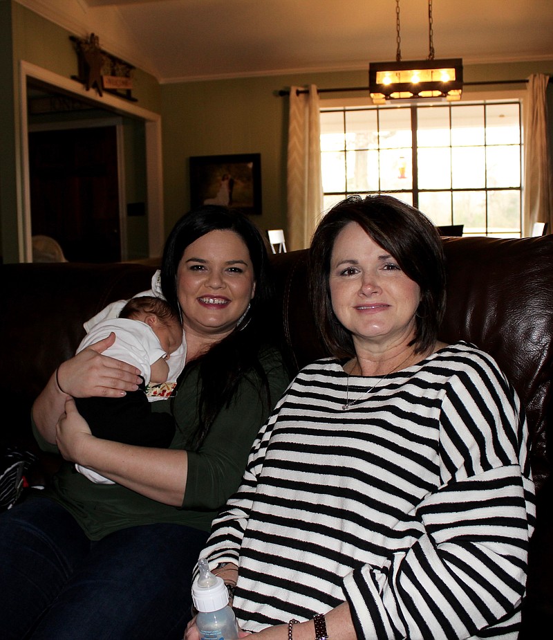 Grandmother Patty Resecker, right, visits daughter-in-law Kayla Jones and new grandson Kross Jones at their house. Patty gave birth to Kross on Dec. 30, 2017, at a local hospital.