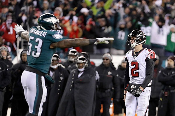 Falcons quarterback Matt Ryan and Eagles linebacker Nigel Bradham react after the Falcons fail to score on fourth-and-goal during the second half of Saturday's divisional playoff game in Philadelphia.